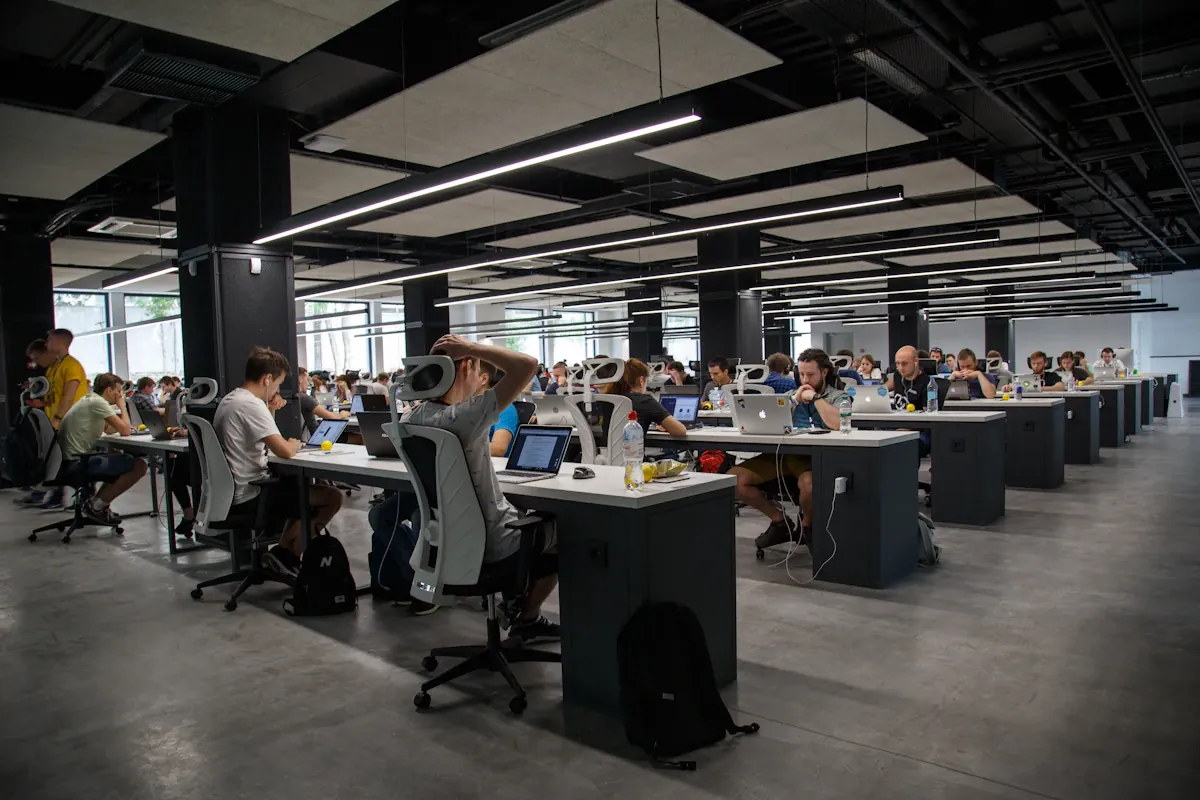 People working at desks in a large open-plan office